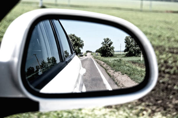 istock summer road in the reflection of the rear view mirror 1212771233