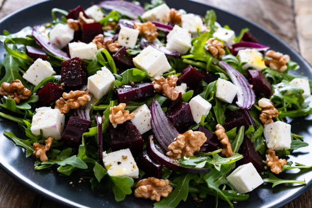 istock Beetroot salad with goat cheese on wooden background 1212773494