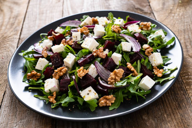 istock Beetroot salad with goat cheese on wooden background 1212773642