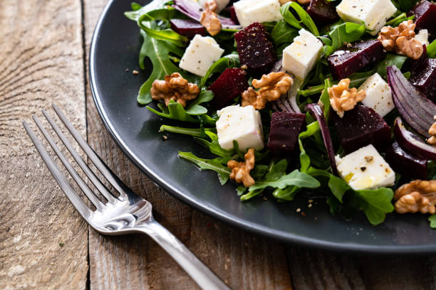istock Beetroot salad with goat cheese on wooden background 1212773743