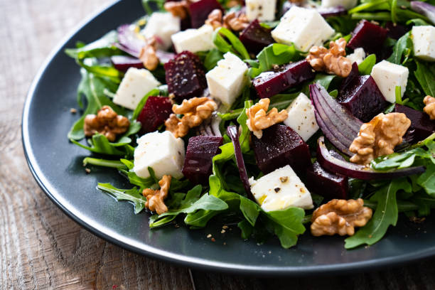 istock Beetroot salad with goat cheese on wooden background 1212773796