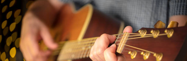 istock Man playing an acoustic guitar during a concert 1212775008