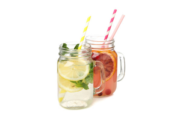 istock Glass jars of lemonade isolated on white background 1212775677