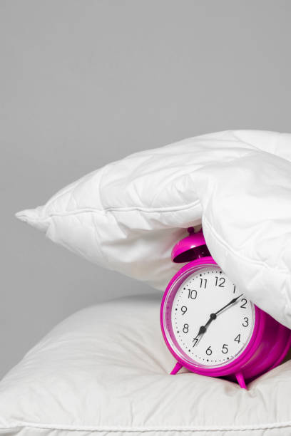 istock Alarm clock under the pillow - Don't want to wake up concept 1212775755