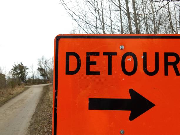 istock orange detour sign with black arrow with trail or path 1212777918