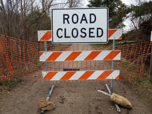 istock white road closed sign and striped barricade with trail or path 1212778086