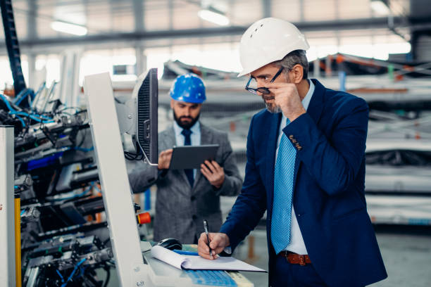 istock Engineers talking while inspecting machinery stock photo 1212779579