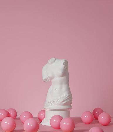 Plaster model of female torso (mass produced replica of Venus de Milo) and pink color balls