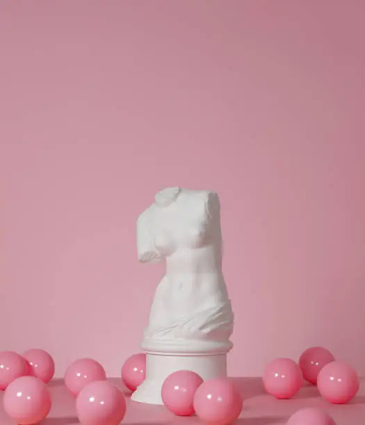 Plaster model of female torso (mass produced replica of Venus de Milo) and pink color balls