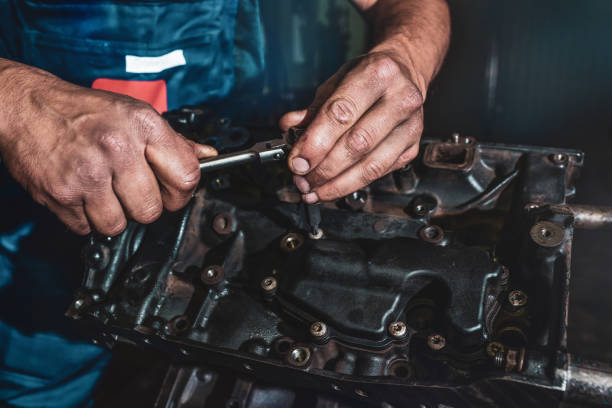 istock The auto mechanic deconstructs the internal combustion engine. Repair service. 1212781375