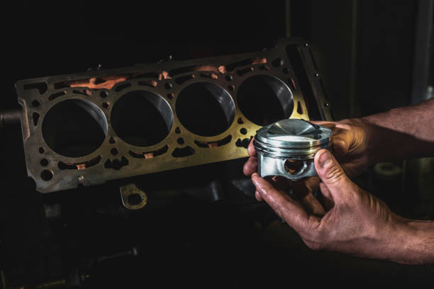 istock Engine cylinder in the hands of a mechanic. Auto engine repair services. 1212782080
