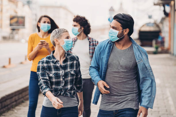 istock Group of people during walking outdoors during flu epidemic 1212782108