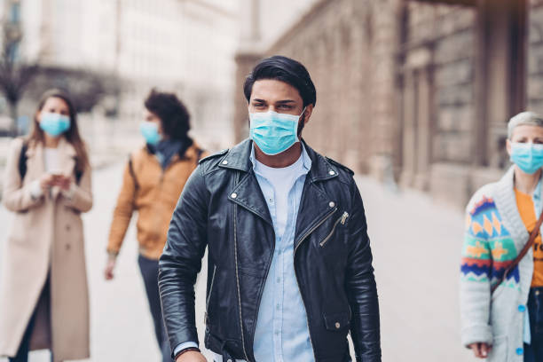 istock Multi-ethnic group of people wearing protective masks 1212782114