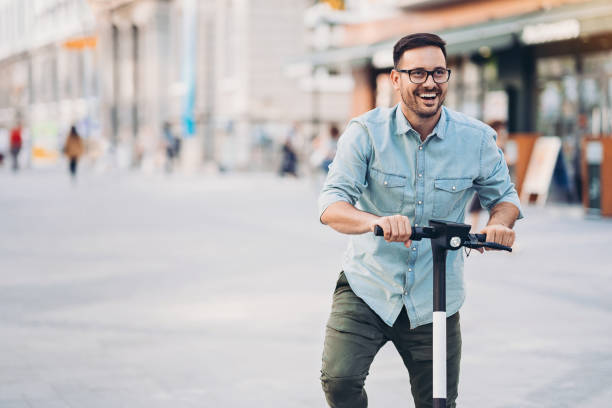 istock Man enjoying an e-scooter ride in the city 1212782122