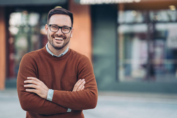 istock Smiling man outdoors in the city 1212782126
