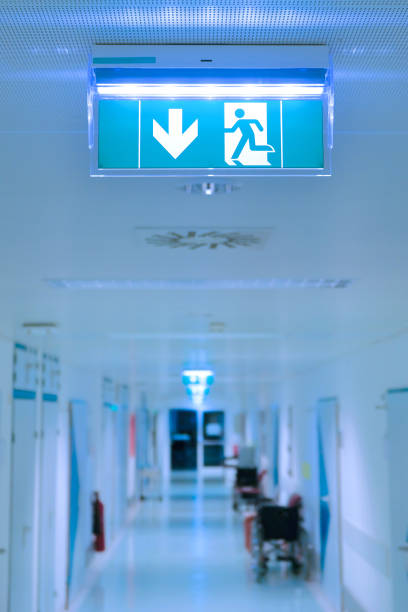 Empty hospital hallway. Exit sign. Medical healthcare concept. Empty hospital hallway. Exit sign. Medical healthcare concept. healthcare and medicine business hospital variation stock pictures, royalty-free photos & images