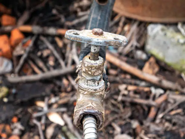 Photo of Old plumbing water tap with a metal valve.