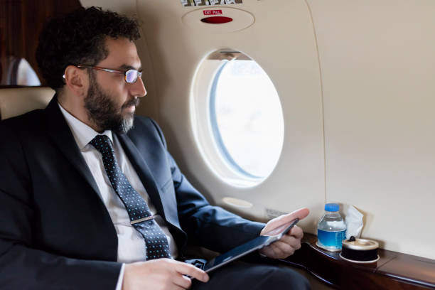 istock Man in private jet airplane 1212783559