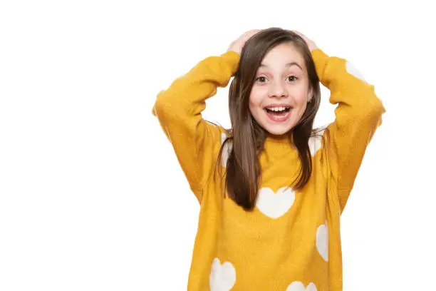Wow. Studio portrait of an adorable young schoolgirl screaming with excitement, isolated on white backgroud. Human emotions and facial expressions concept.