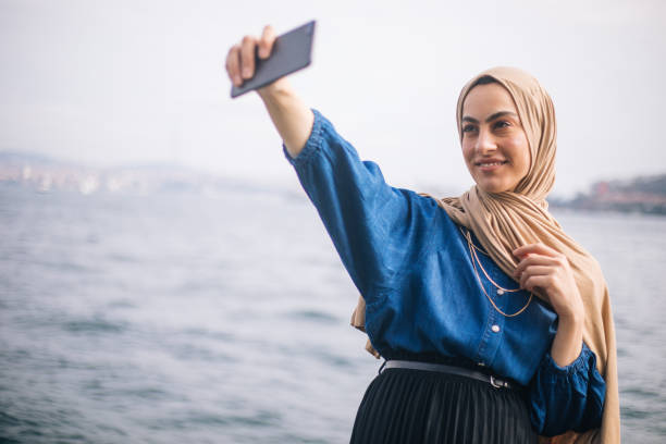 istock Happy young woman taking selfie 1212784914