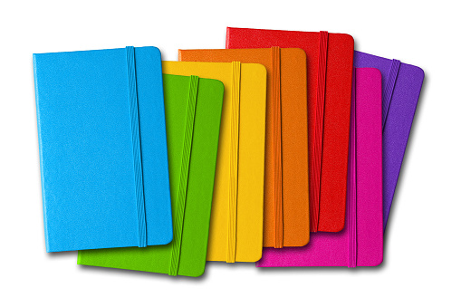 Multi color closed notebooks range isolated on white