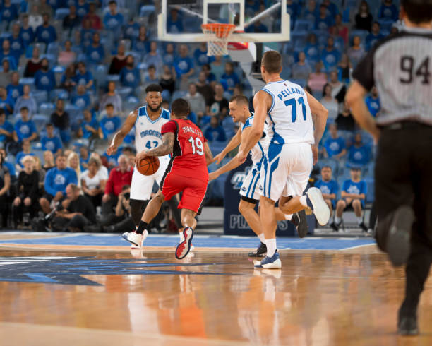 istock Basketball players chasing for ball 1212788840