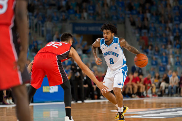 istock Basketball players chasing for ball 1212788849