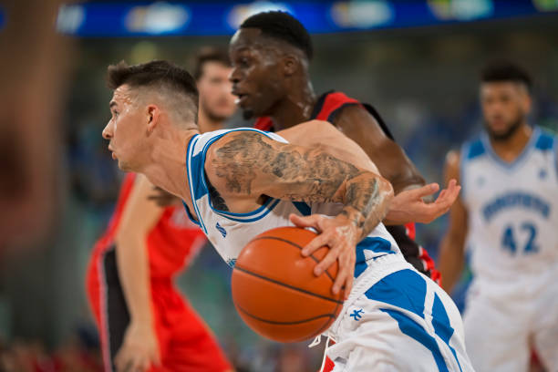 istock Basketball player dribbling ball 1212788881