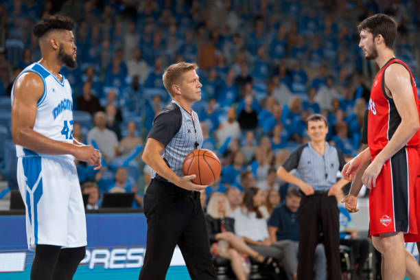 istock Referee with basketball in court 1212788906