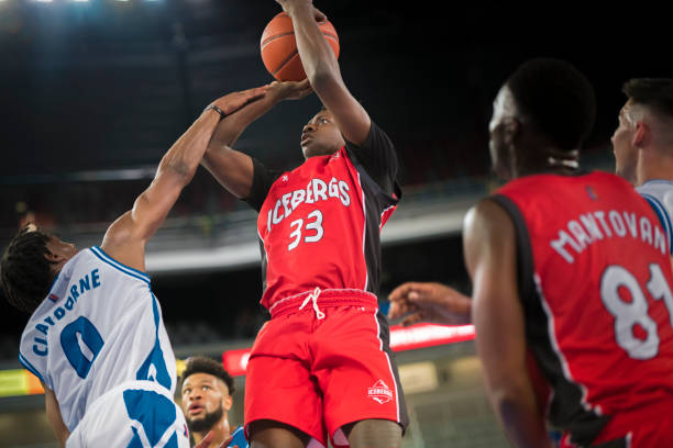 istock Basketball players chasing for ball 1212788908