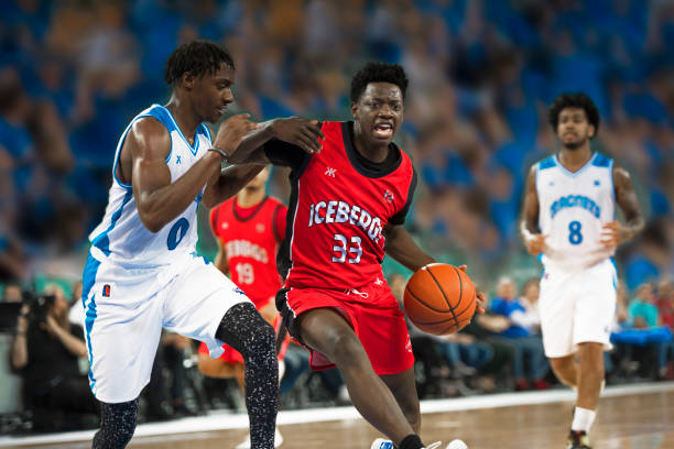istock Basketball players chasing for ball 1212788915