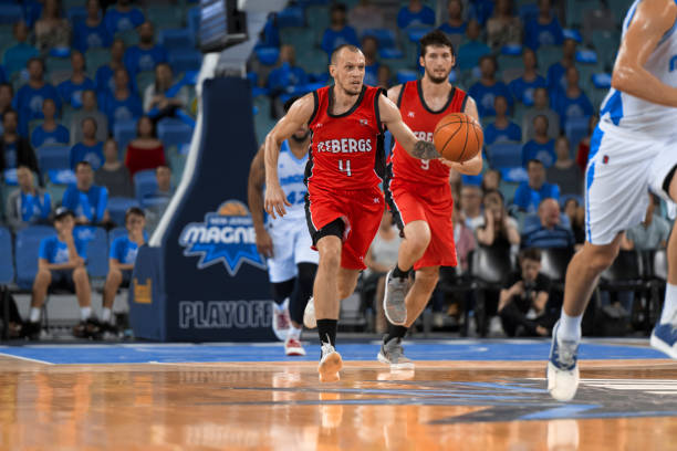 istock Basketball players running with ball 1212788916