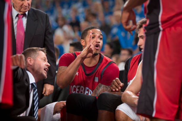 Coach giving instructions to basketball players