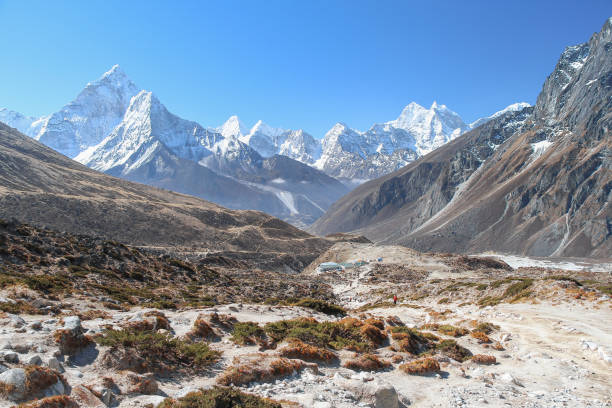 istock Ama Dablam mountain peak rises above mountain valley in Himalayas 1212791610