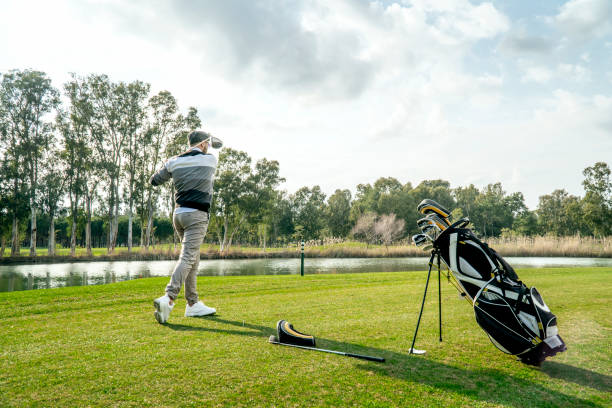 istock Portrait of a young golfer teeing off in golf course 1212791759