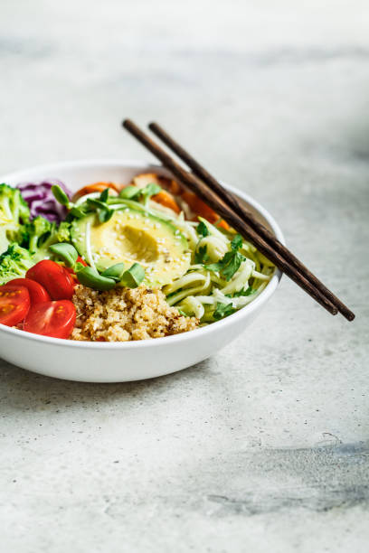 istock Quinoa salad with broccoli, tomatoes and avocado in white bowl. 1212791899