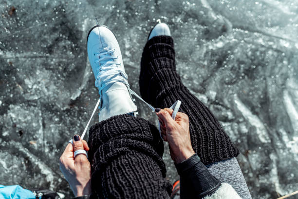 istock An unrecognizable woman changing between ice skates and shoes while sitting down at the edge of ice 1212792549