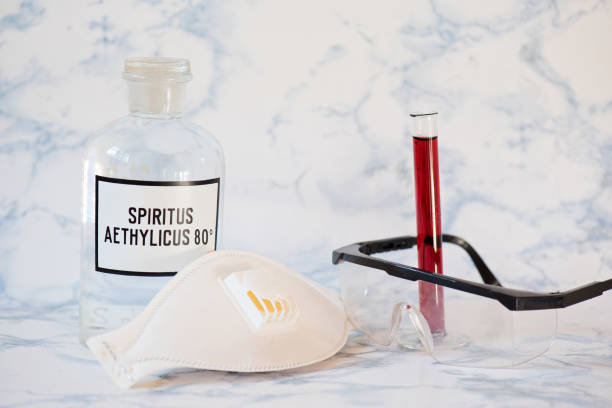 istock Ethanol in a bottle, protecting mask, blood analysis and glasses 1212793334