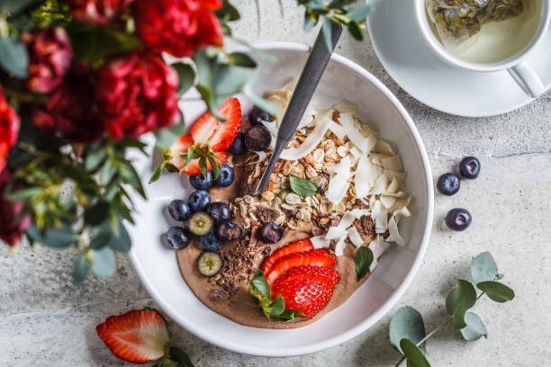istock Healthy breakfast bowl with granola, berries and coconut, top view. 1212794013