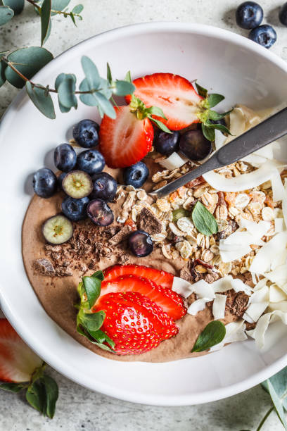 istock Healthy breakfast bowl with granola, berries and coconut, top view. 1212794090