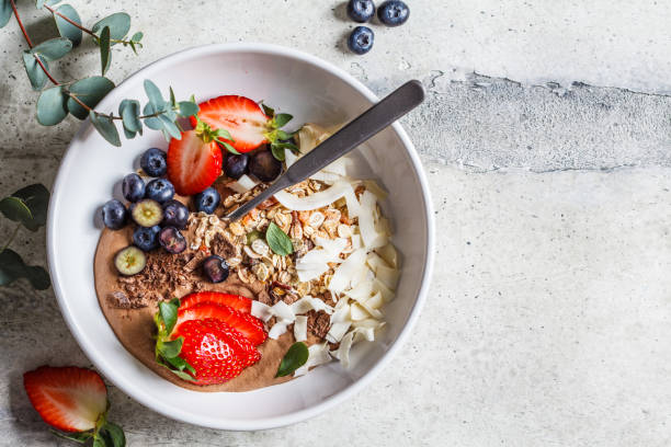 istock Healthy breakfast bowl with granola, berries and coconut, top view. 1212794114