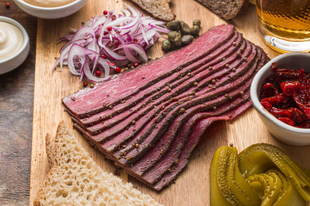 Sliced Deli Pastrami on wooden board, flat lay Sliced Deli Pastrami on wooden board, flat lay. pastrami stock pictures, royalty-free photos & images