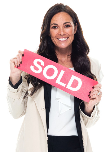 Portrait of aged 40-44 years old who is beautiful with brown hair caucasian young women businesswoman standing in front of white background wearing businesswear who is laughing and holding sign