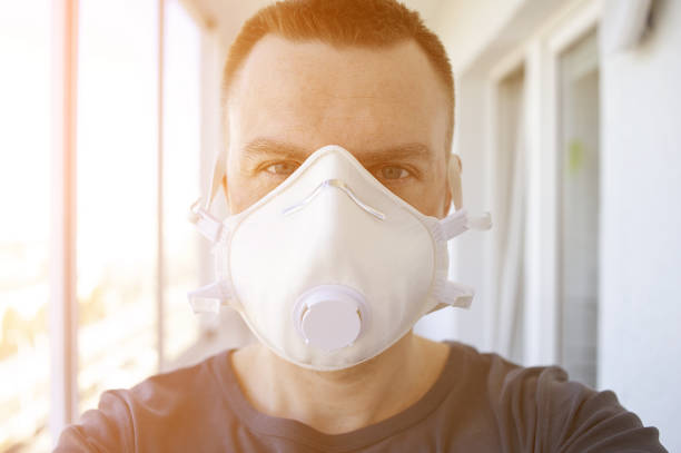istock Young man in protective respiratory mask during coronavirus 1212797998