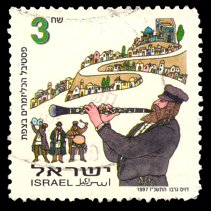 ISRAEL - CIRCA 1997: Postage stamp issued in Israel dedicated to the festival of Jewish folklore klezmer music\nheld in the Israeli city of Safed, circa 1997