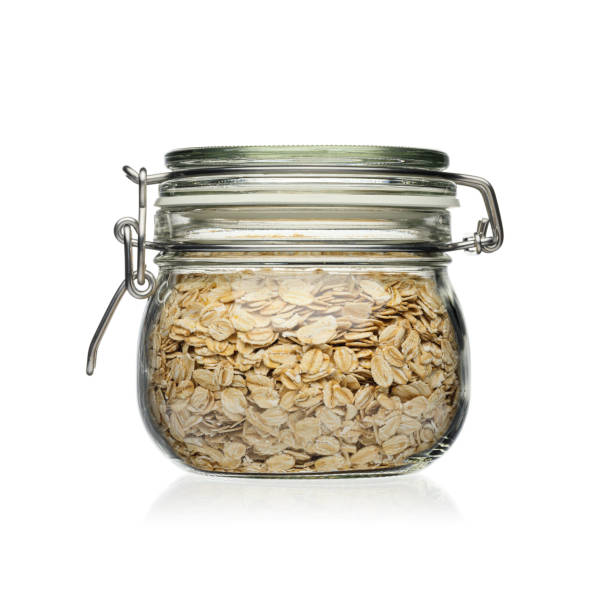 istock Oatmeal in a glass jar isolated on white background. 1212798280