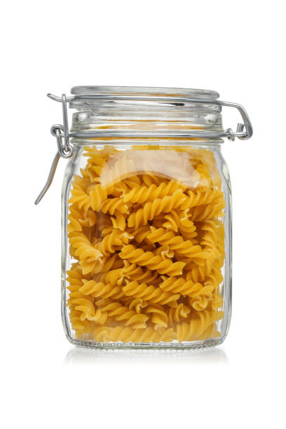 istock Pasta in a glass jar isolated on white background. 1212798516