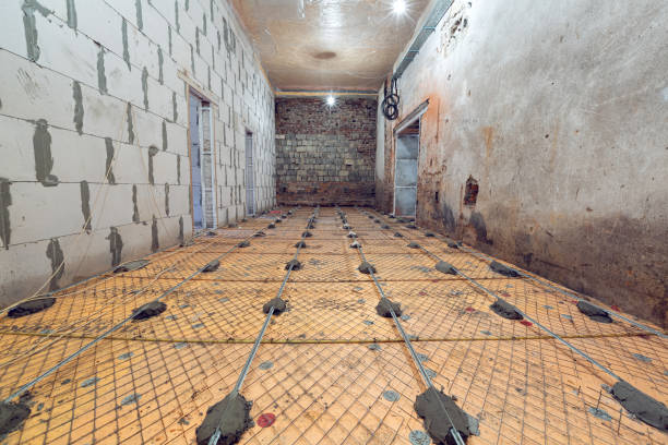 istock Working process of building house with wall made from foamed concrete blocks and floor prerared for pouring by cement. Concept of construction, remodeling, renovation, extension, restoration and reconstruction. 1212800455