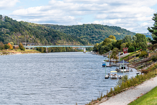 Charleston, USA - October 17, 2019: Kanawha river park path in green autumn in West Virginia capital city with boat ramps and bridge