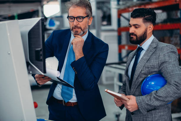 istock Engineers talking while inspecting machinery stock photo 1212802310
